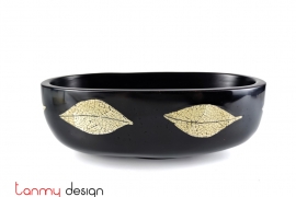 Black oval bowl attached with eggshell leaves
